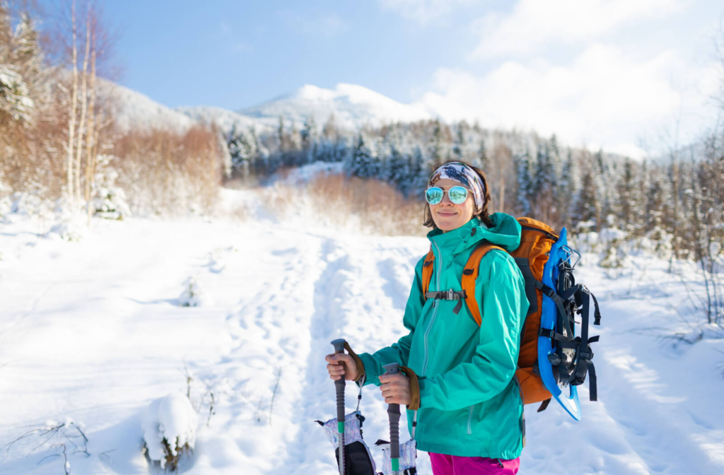 A young cold-weather hiker wearing polarized lenses to protect her eyes from glare.