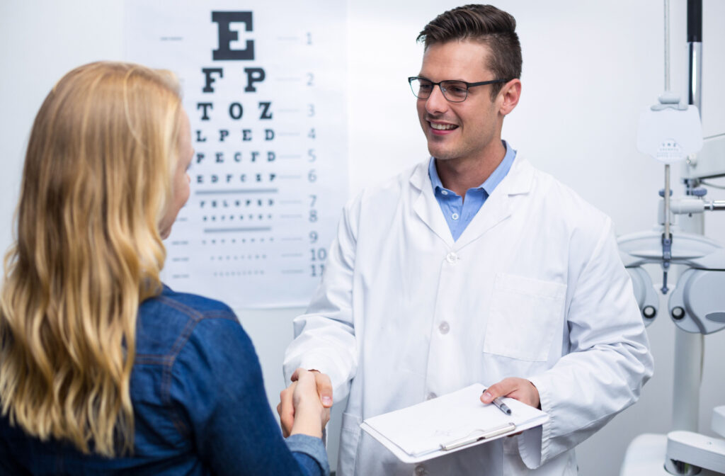 A woman in an optometry clinic shaking hands with his male optometrist.