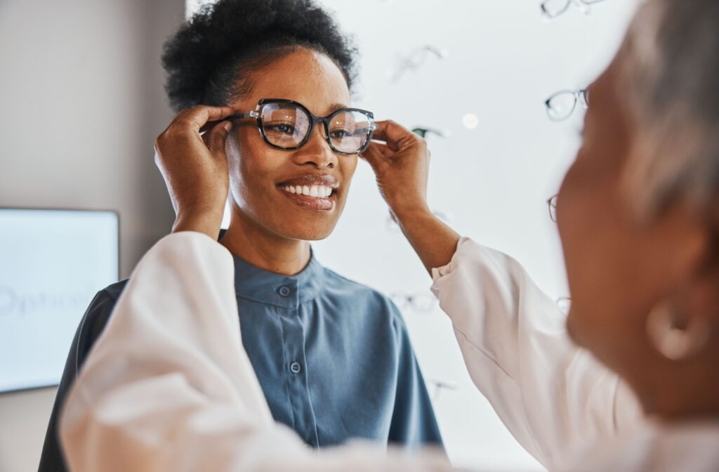 A woman is getting fitted for a new pair of eye glasses.