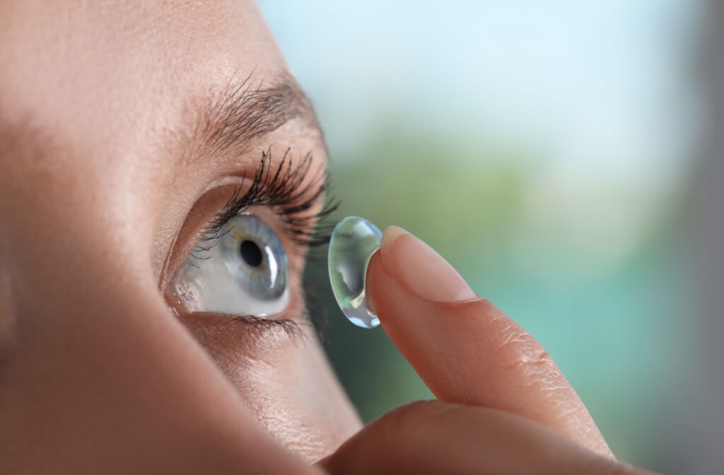 A person putting in scleral contact lenses.